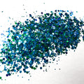 A green and blue chunky glitter mix on a white background.