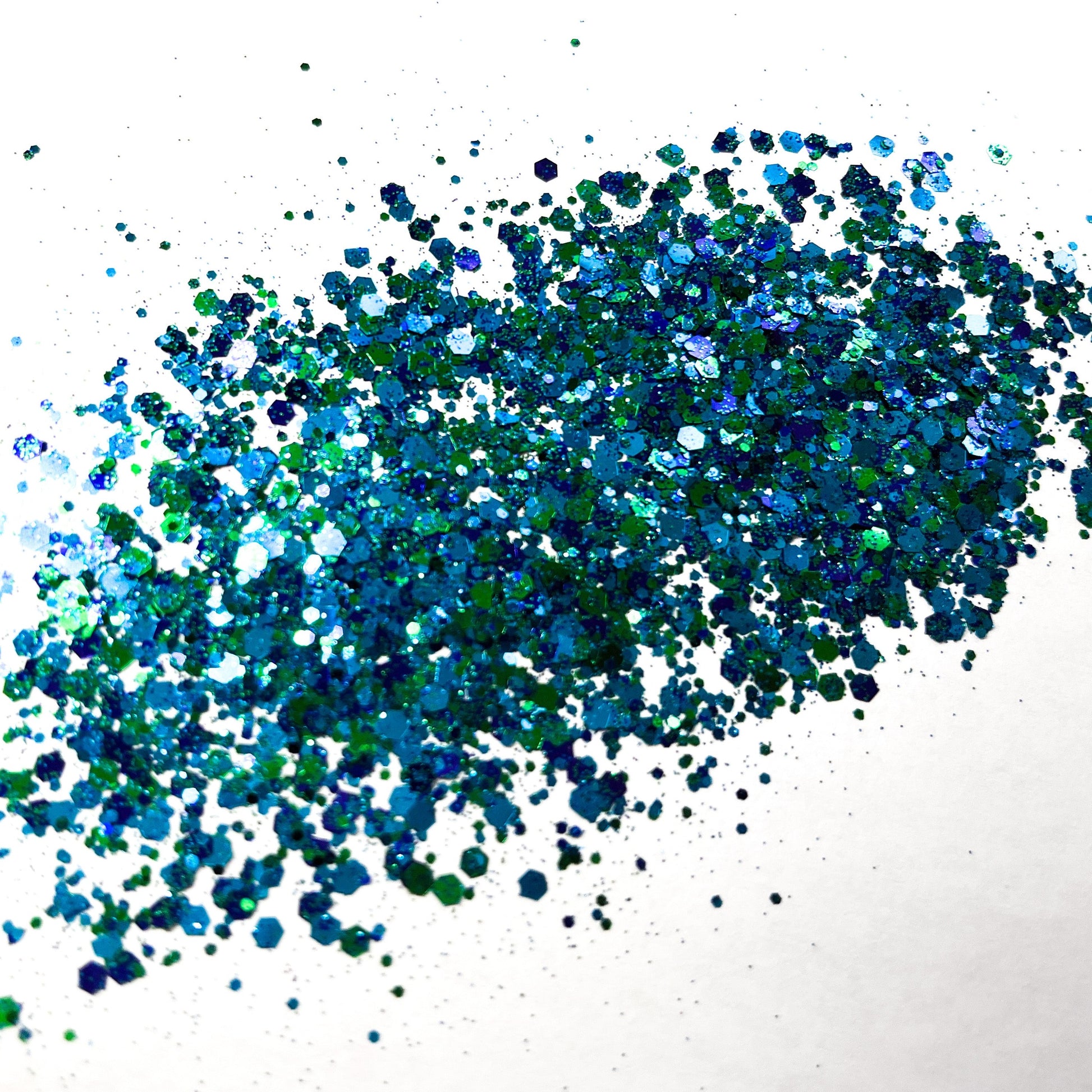 A green and blue chunky glitter mix on a white background.