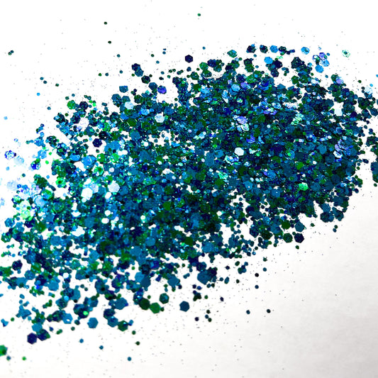 A green and blue chunky glitter mix on a white background.