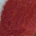 A pile of extra fine glitter in shades of maroon, burgundy and purple.