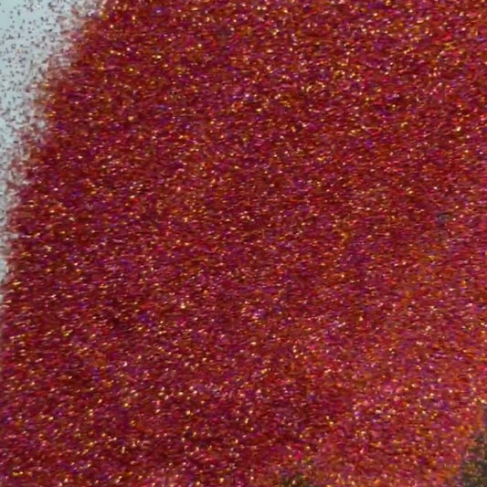 A pile of extra fine glitter in shades of maroon, burgundy and purple.