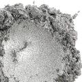 A close-up image of silver-colored mica powder with a metallic sheen.