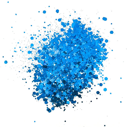 A pile of royal blue chunky glitter on a white background.