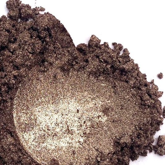 A pile of brown mica powder on a white background.