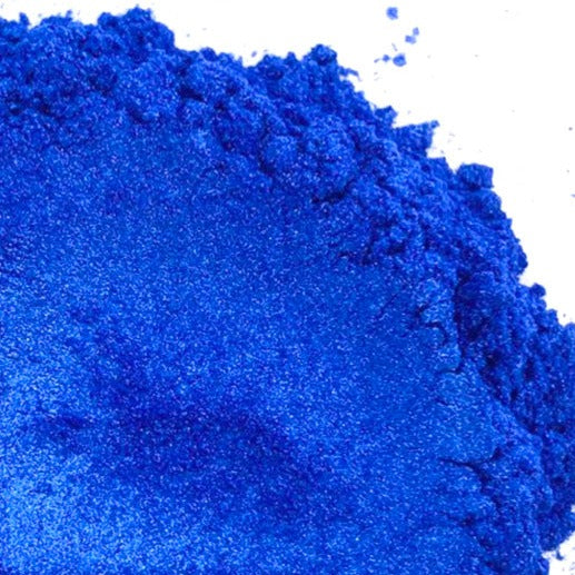 A pile of blue mica powder on a white background.
