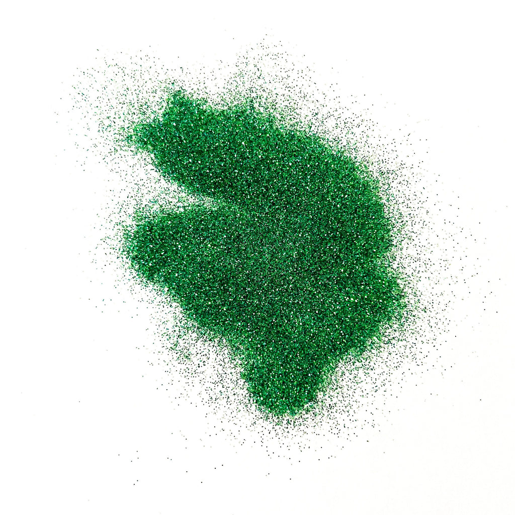 A pile of green glitter on a white background.