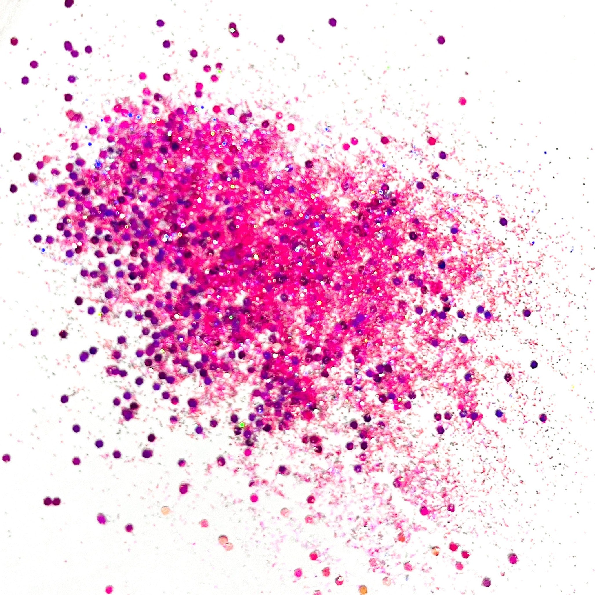 A pile of pink and purple glitters on a white background.