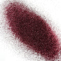 An extra fine maroon glitter pile on a white background.