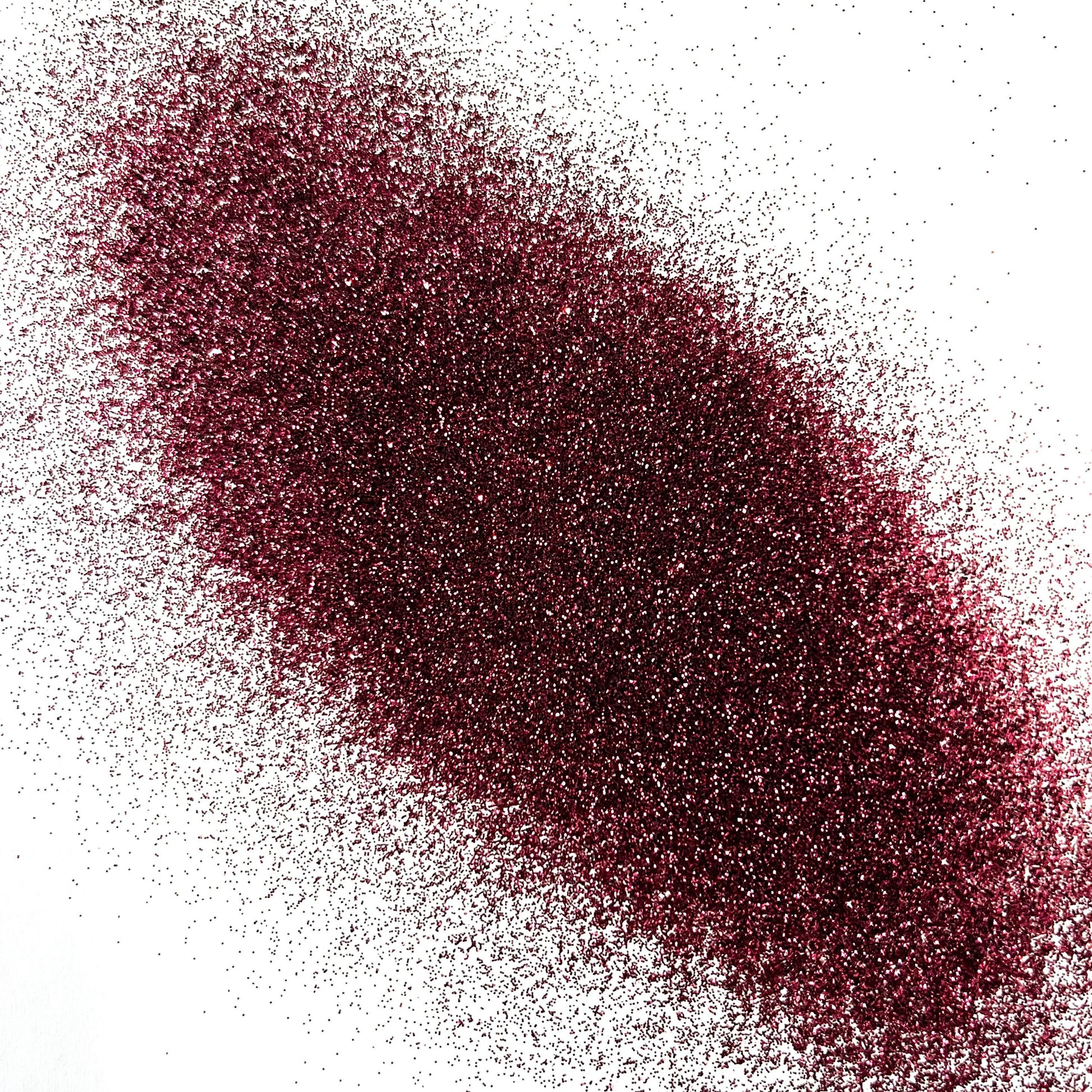 An extra fine maroon glitter pile on a white background.