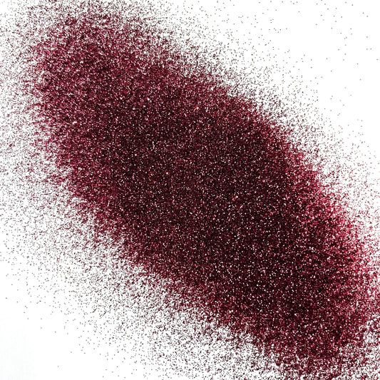 An extra fine maroon glitter pile on a white background.