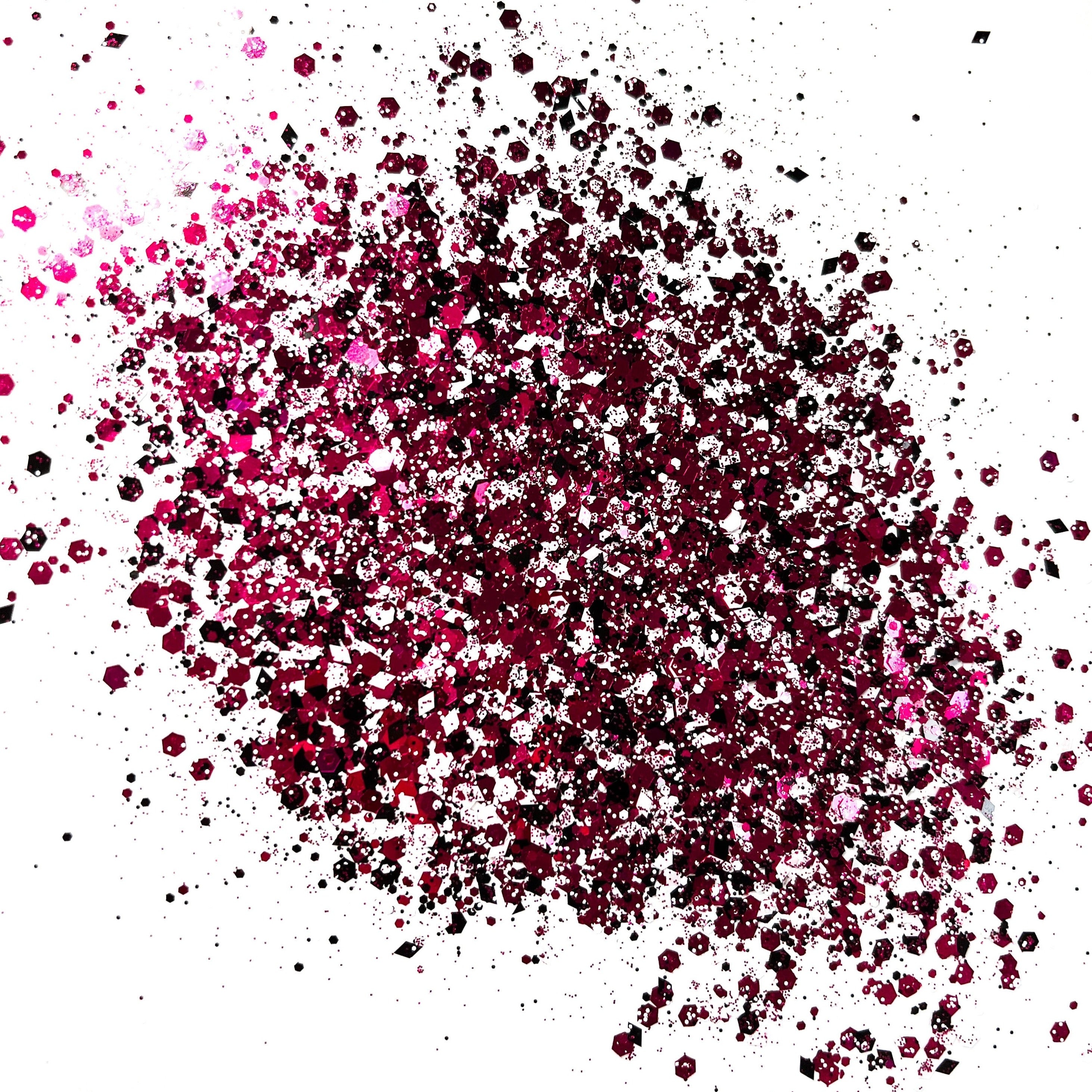 A pink/bkack/white chunky glitter mix on a white background.