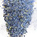 A pile of mixed colours of chunky glitter, including Blue/Yellow/White/Silver on a white background.