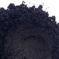 A pile of black mica powder on a white background.