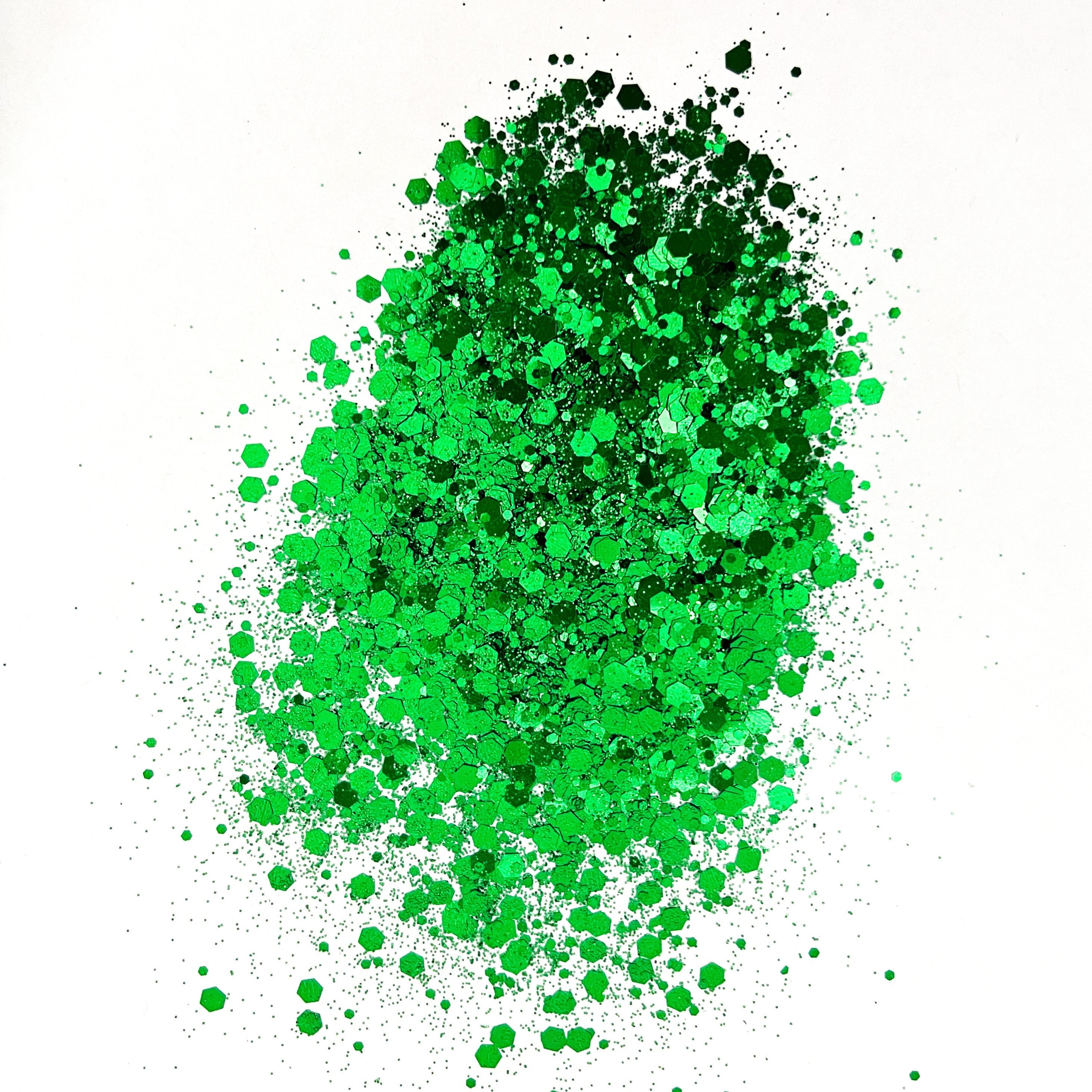 A pile of green polyester glitter spread out on a white background.