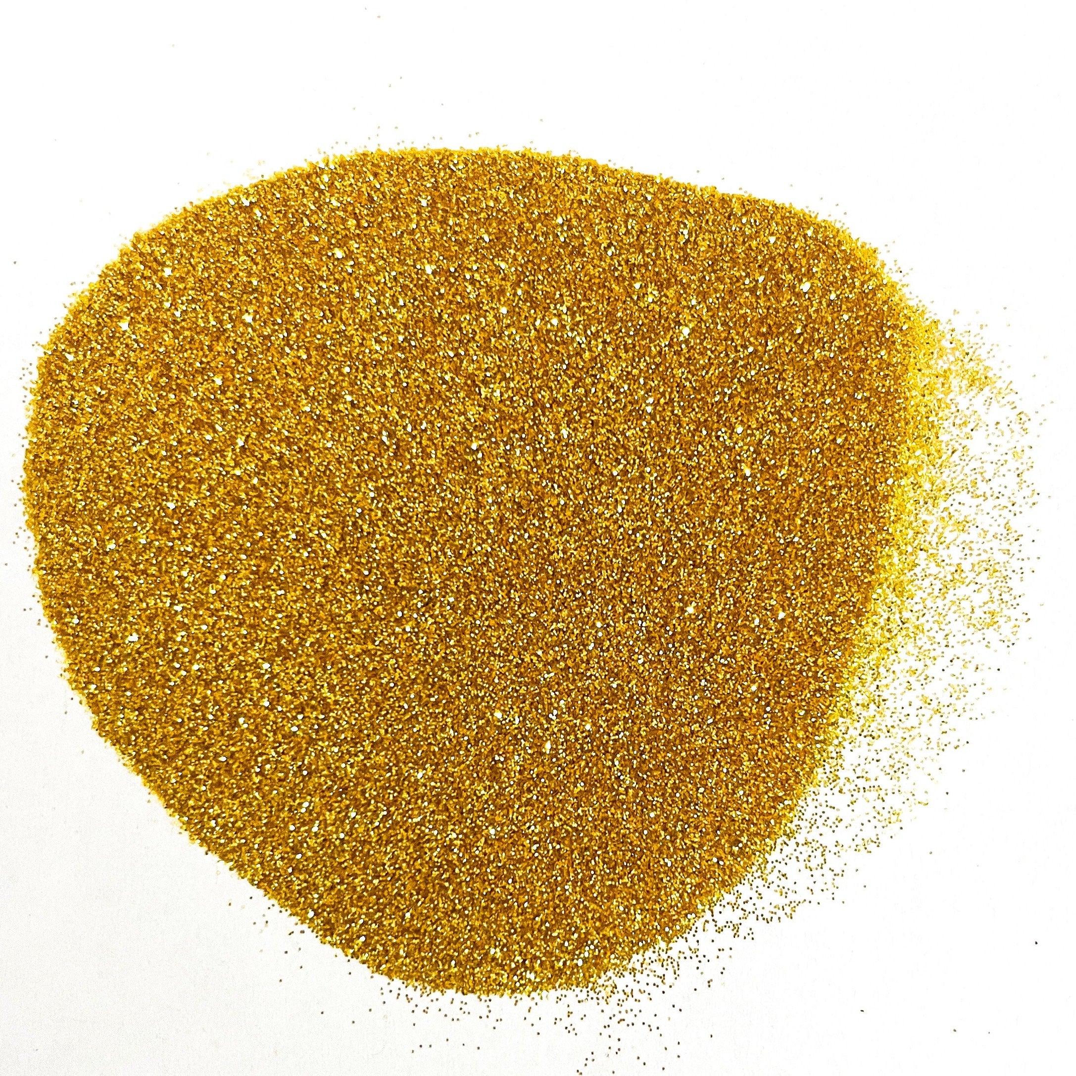 A pile of yellow metallic glitter on a white background