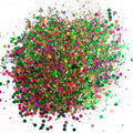 A colorful mix of chunky glitter in green, pink, and purple hues, resembling a chameleon or colour shift effect.