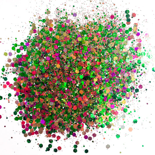 A colorful mix of chunky glitter in green, pink, and purple hues, resembling a chameleon or colour shift effect.
