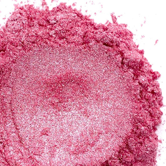 A close-up image of pink mica powder with a shimmering finish.