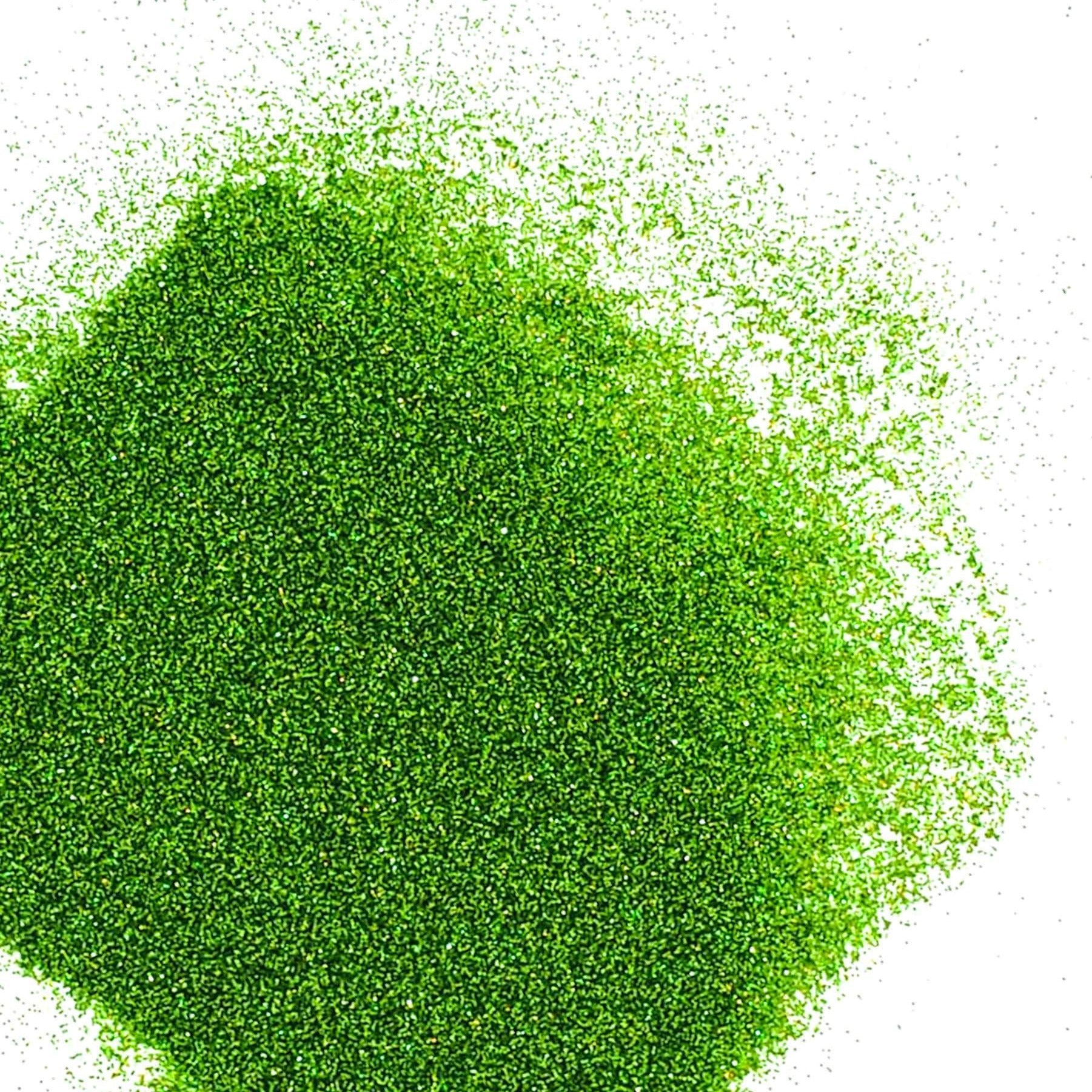 A pile of green holographic glitter, in extra fine on a white background.