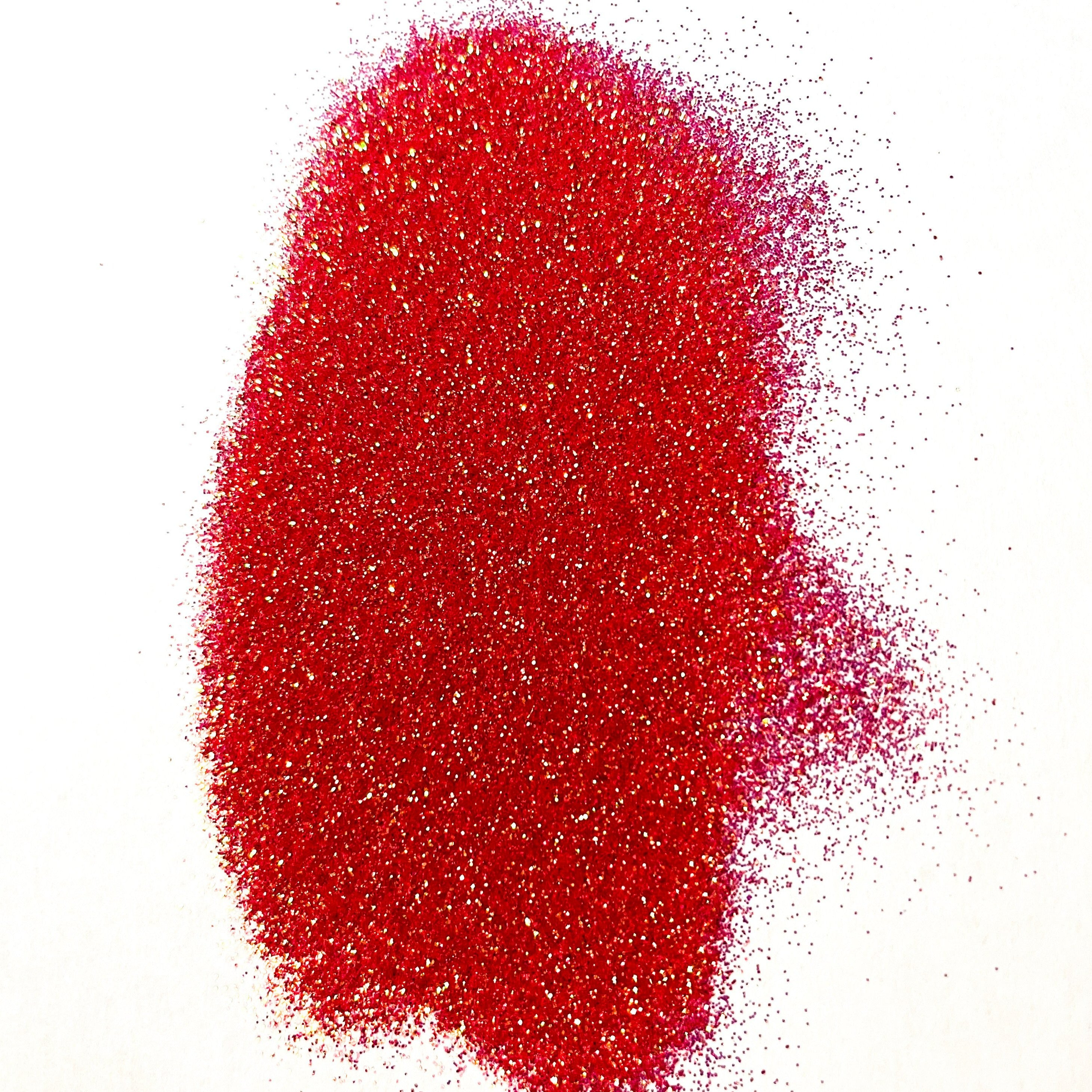 An extra fine red glitter pile on a white background.