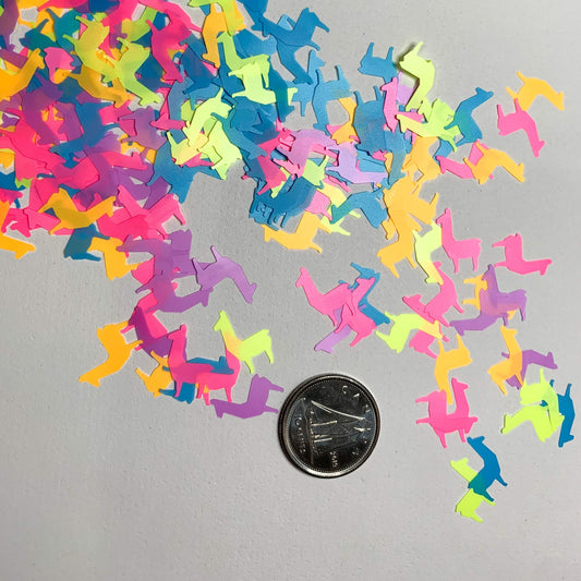 Neon rainbow llamas shaped glitter white background with a dime used to show size reference. 