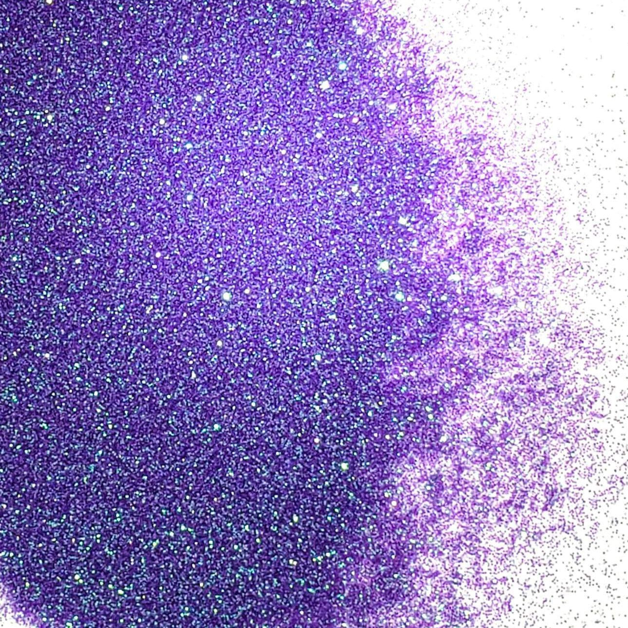 A close-up image of purple iridescent glitter, showing the fine particle size and reflective properties.