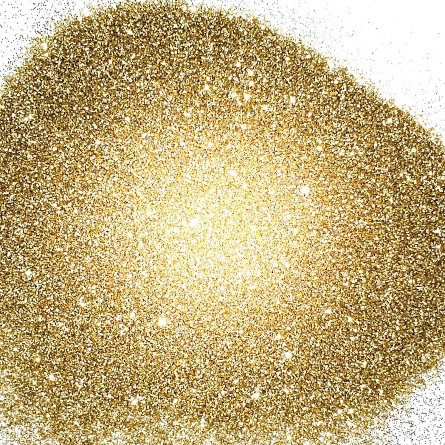 A pile of extra fine gold glitter with a sparkling, shimmering finish.