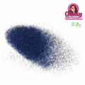 A pile of blue iridescent biodegradable glitter on a white surface with a logo in the corner.