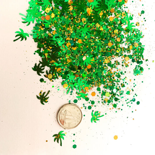 Green Palm tree shaped glitter with green and gold chunky glitters on a white background with a dime used to show size reference. 