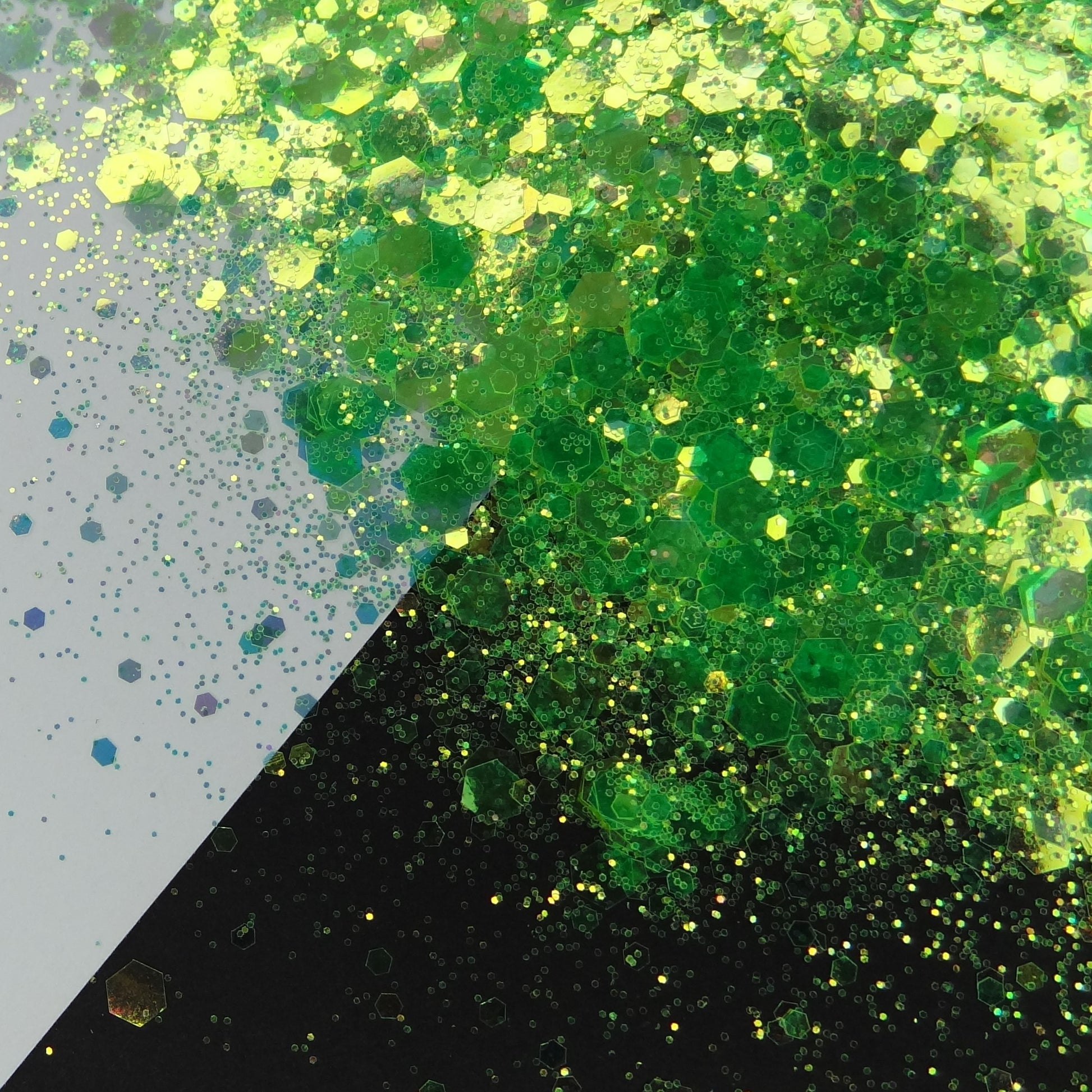 A green chunky glitter mix spread out on a black and white background.