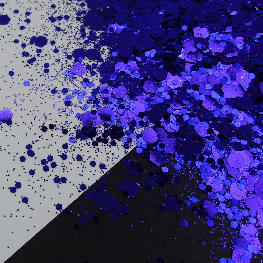 A pile of indigo chunky glitter on a black and white background.