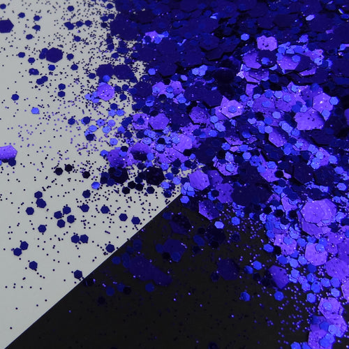 A pile of indigo chunky glitter on a black and white background.