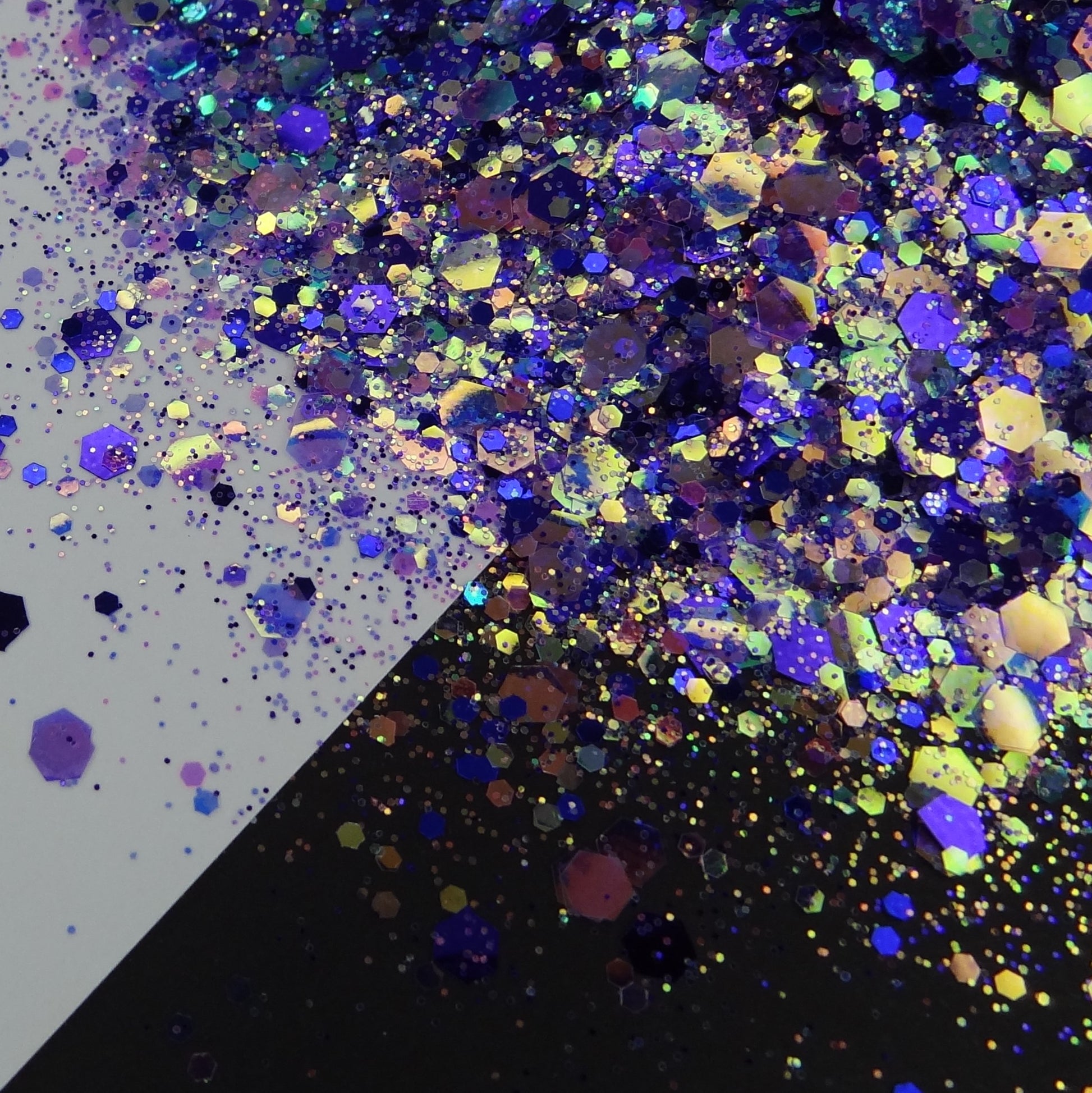 A purple chunky glitter mix spread out on a black and white background.