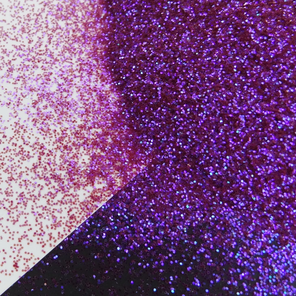A purple glitter mix spread out on a black and white background.