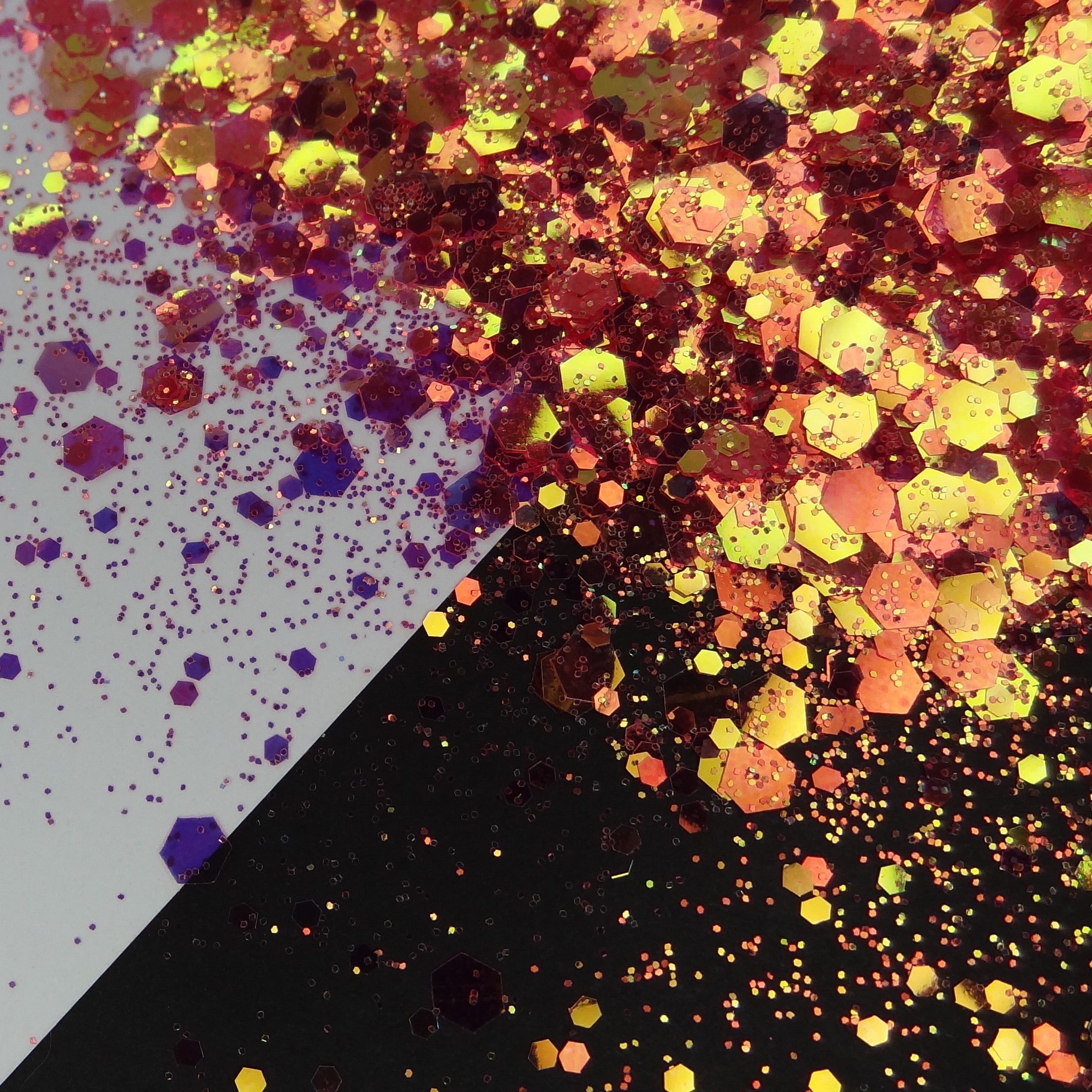 A burnt orange/gold chunky glitter mix spread out on a black and white background.