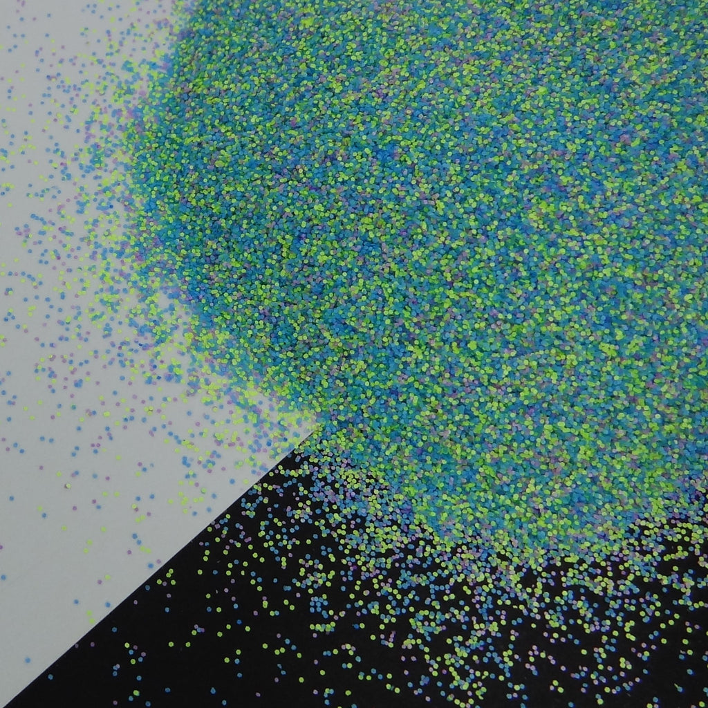 Blue, Green and Yellow matte glitter fanned out on a black and white background.