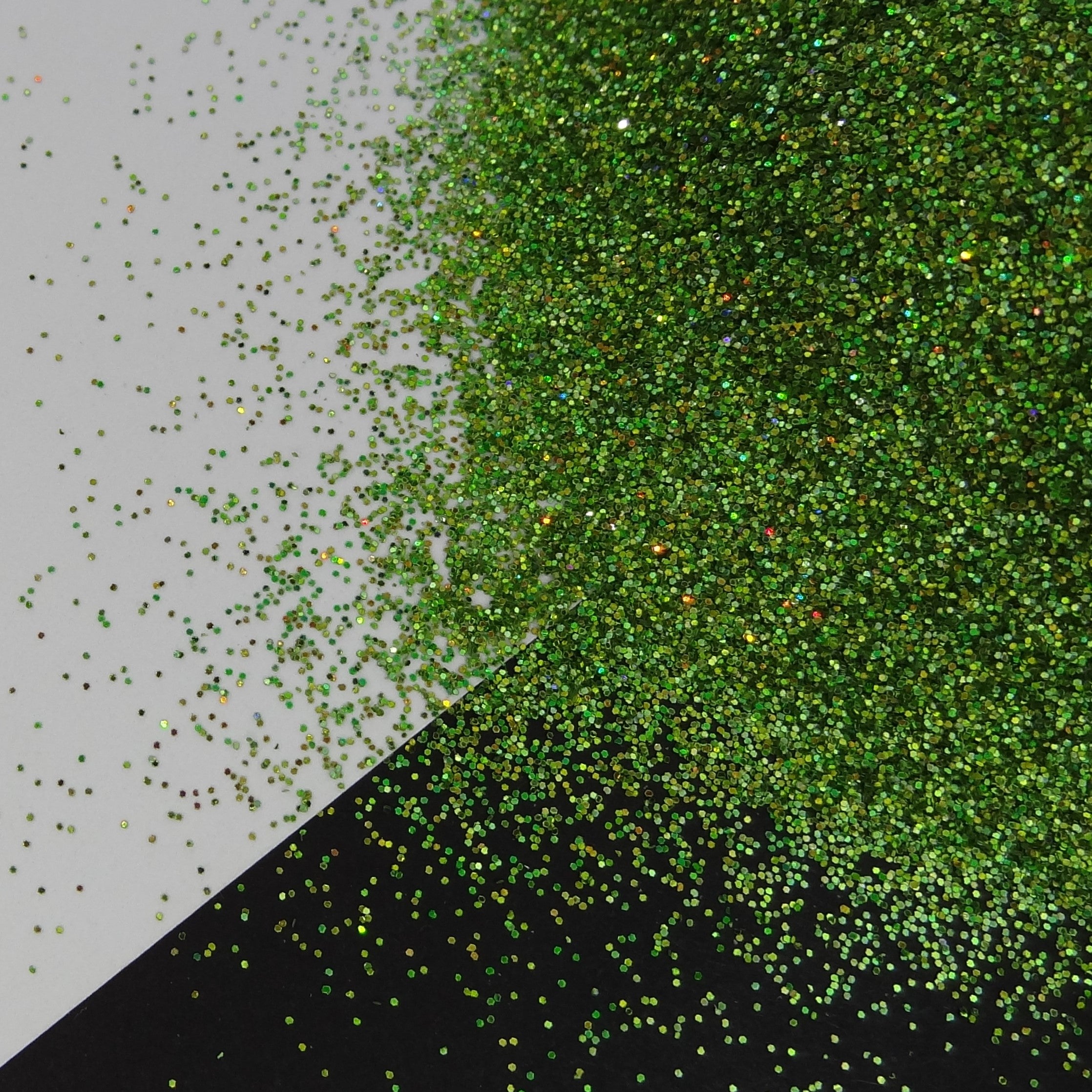 A pile of holographic green glitter on a black and white background.