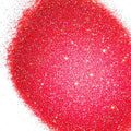 A pile of dark pink glitter, in extra fine on a white background.