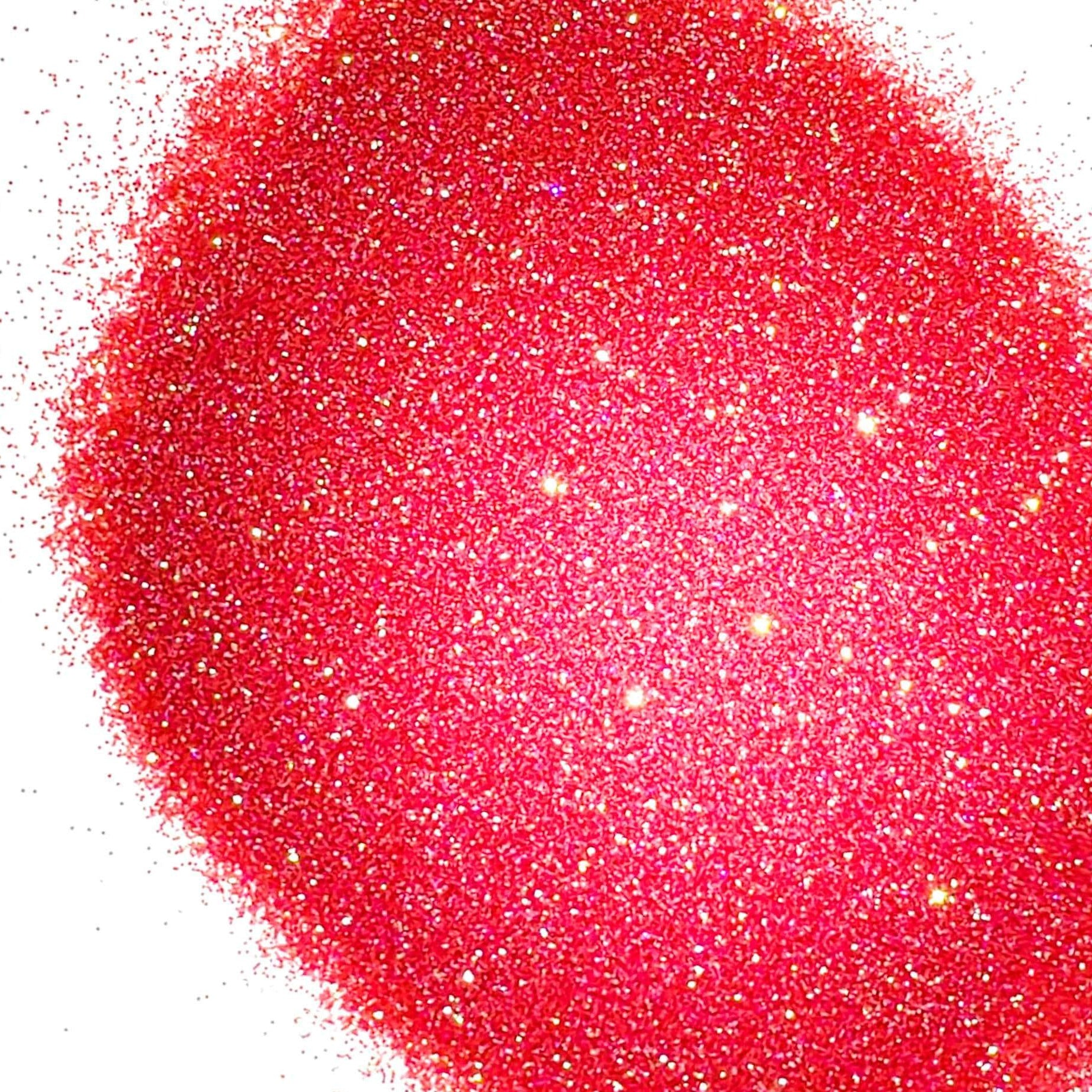 A pile of dark pink glitter, in extra fine on a white background.