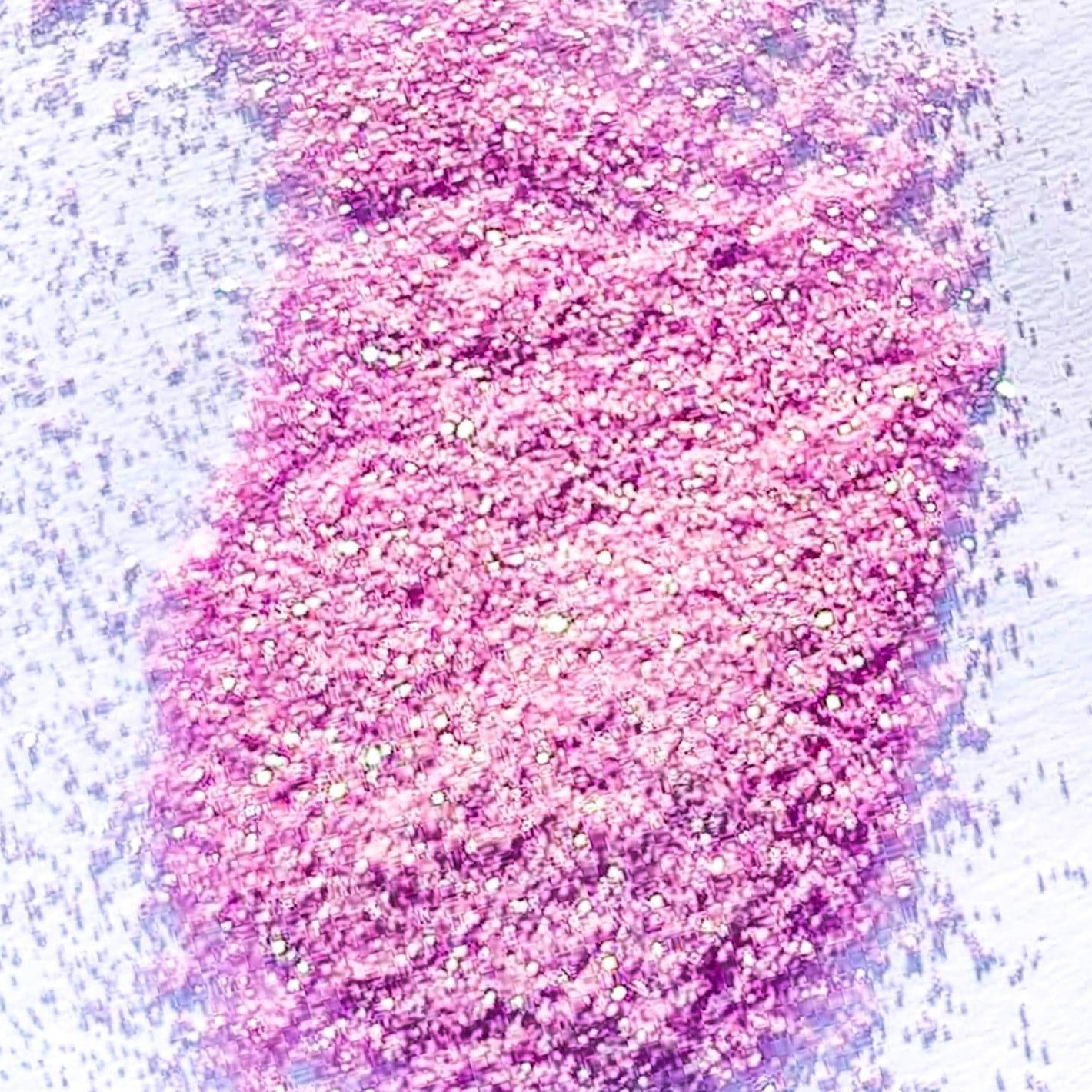 A light pink extra fine glitter on a white background.