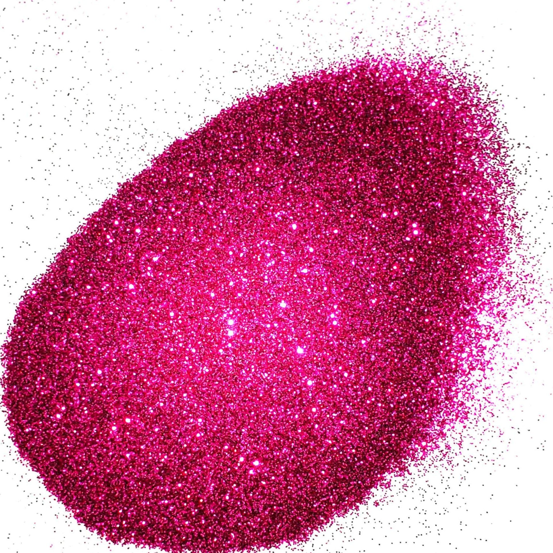 A pile of pink extra fine glitter with a shiny and sparkling appearance.
