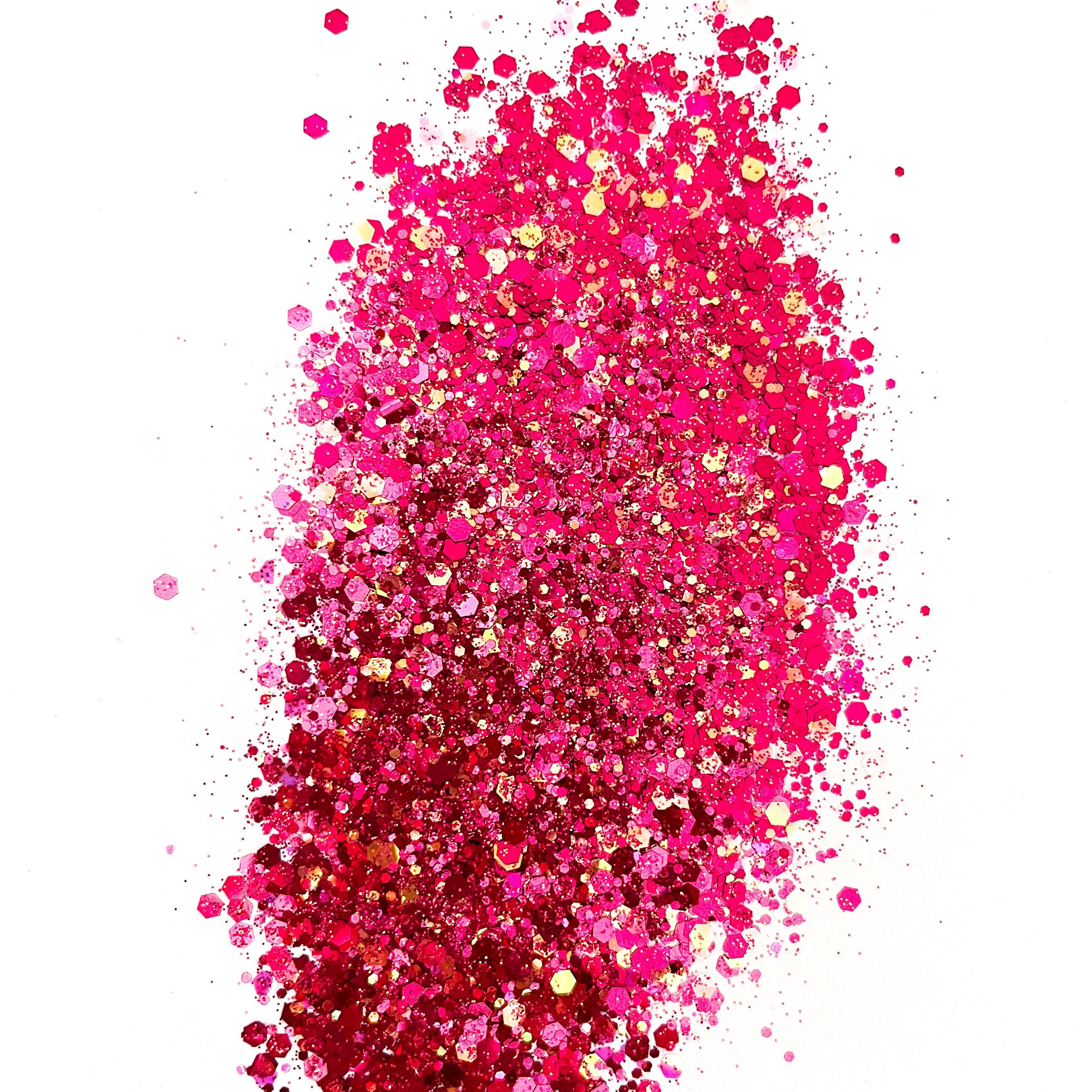 A pile of pink chunky glitter on a white background.