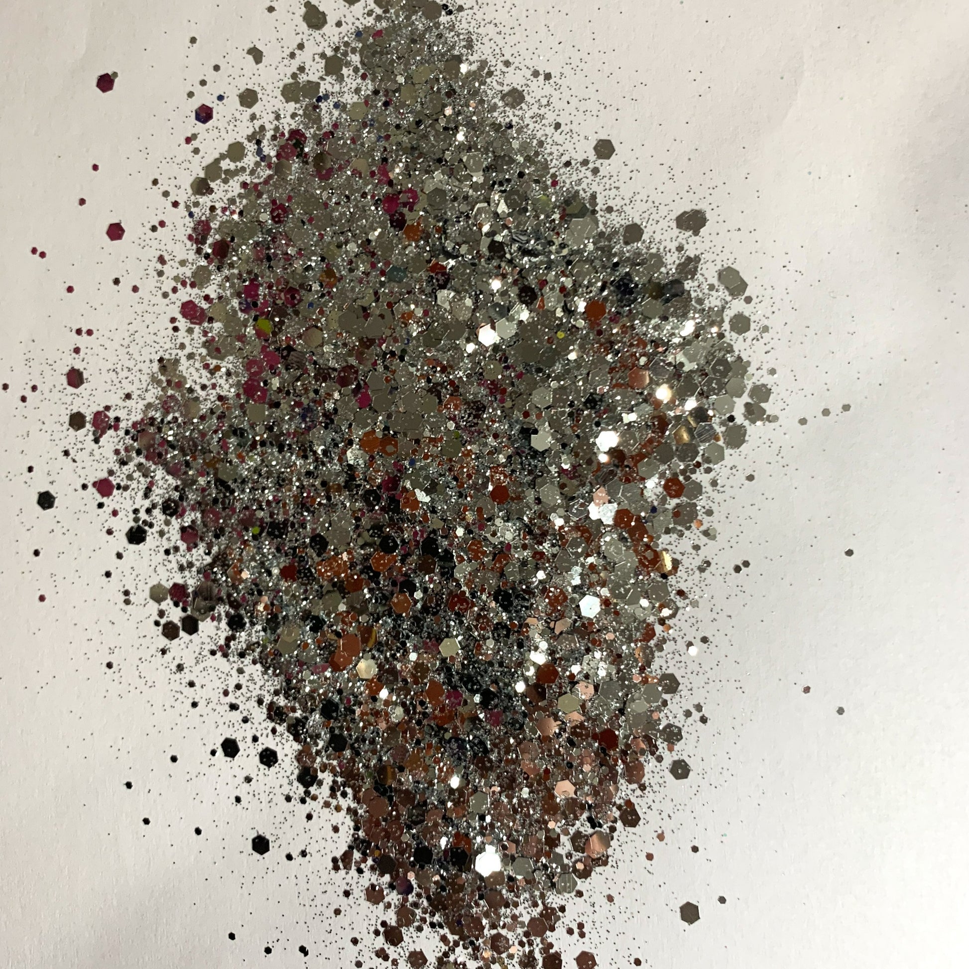 A chunky glitter mix spread out on a white background.