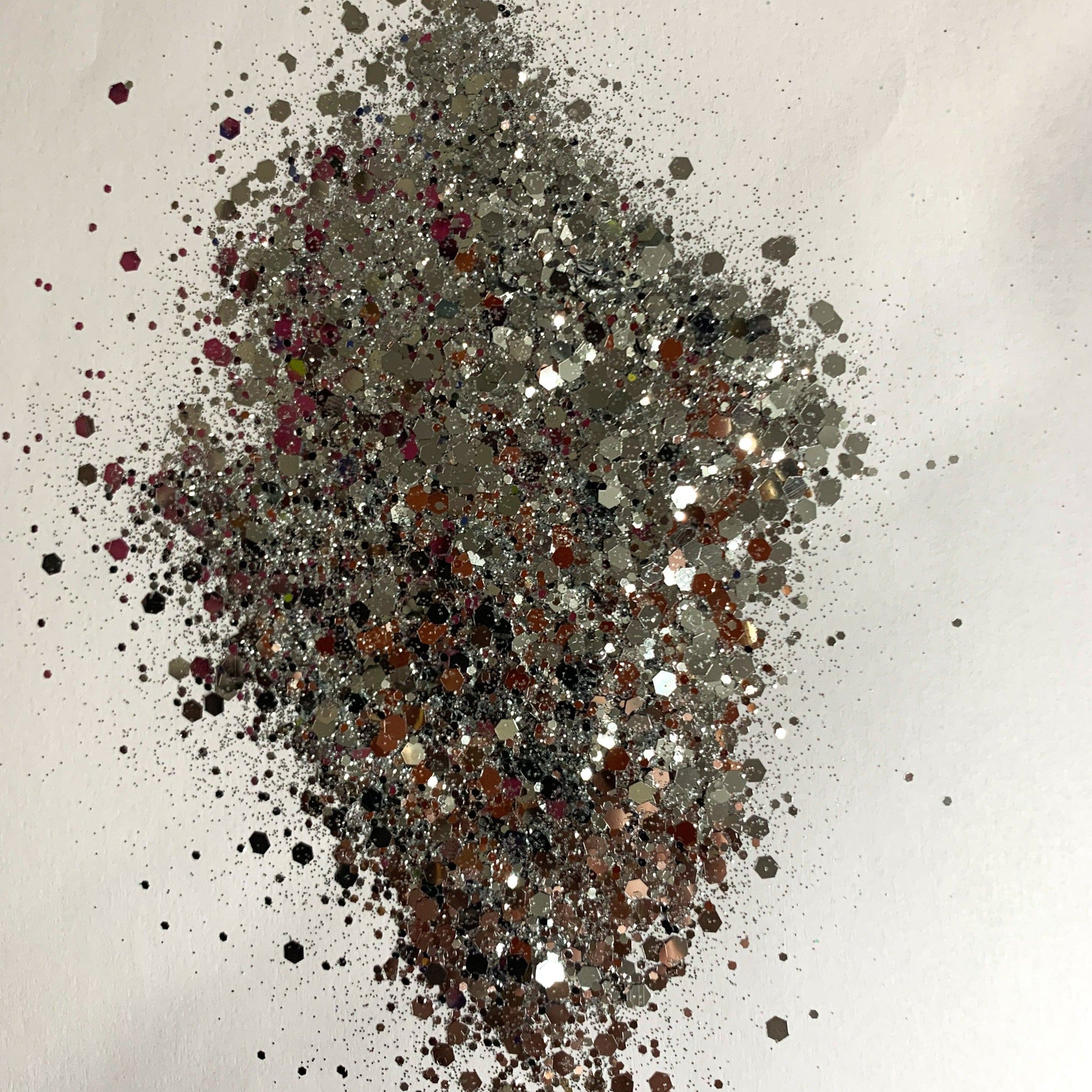 A chunky glitter mix spread out on a white background.