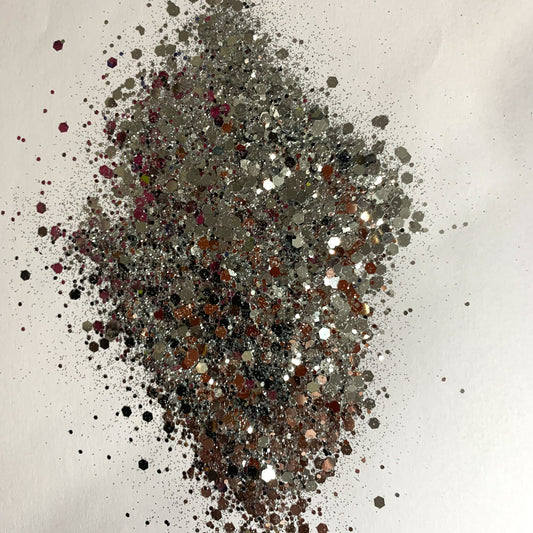 A chunky glitter mix spread out on a white background.