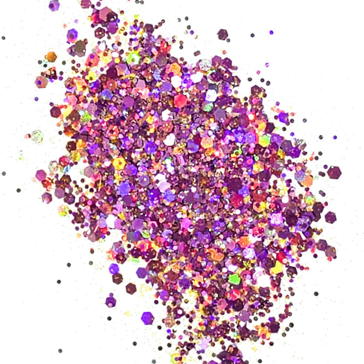 A colorful mix of purple, yellow, and multicolored chunky glitter spread on a white background.