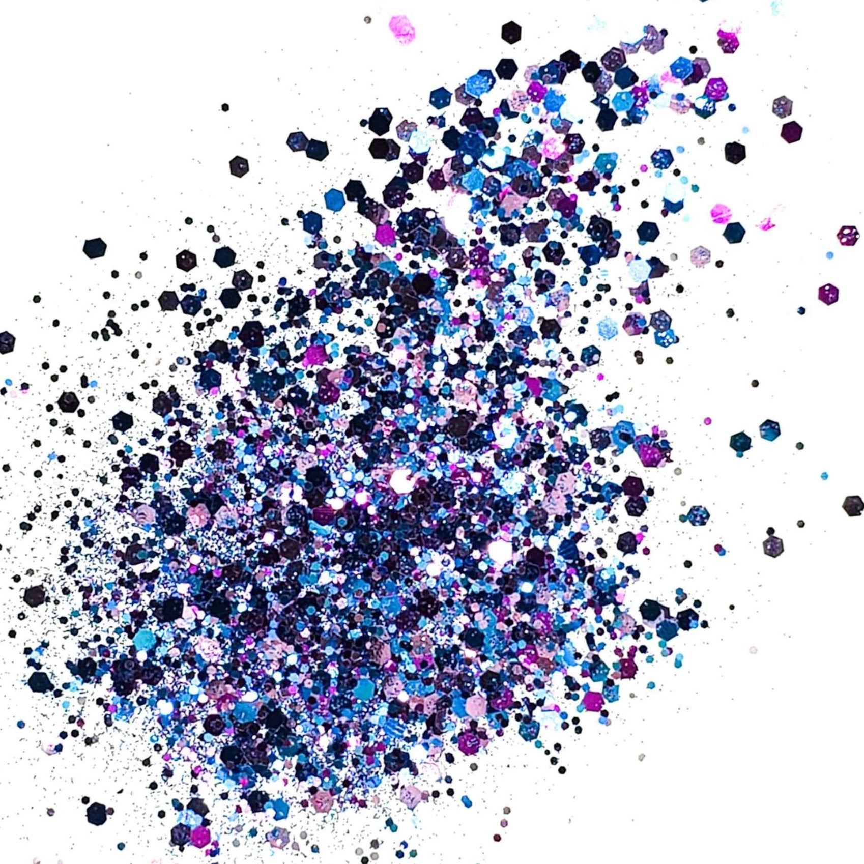 A mix of blue and purple chunky glitter spread out on a white background.