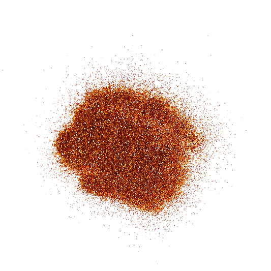 An extra fine bronze glitter pile on a white background.