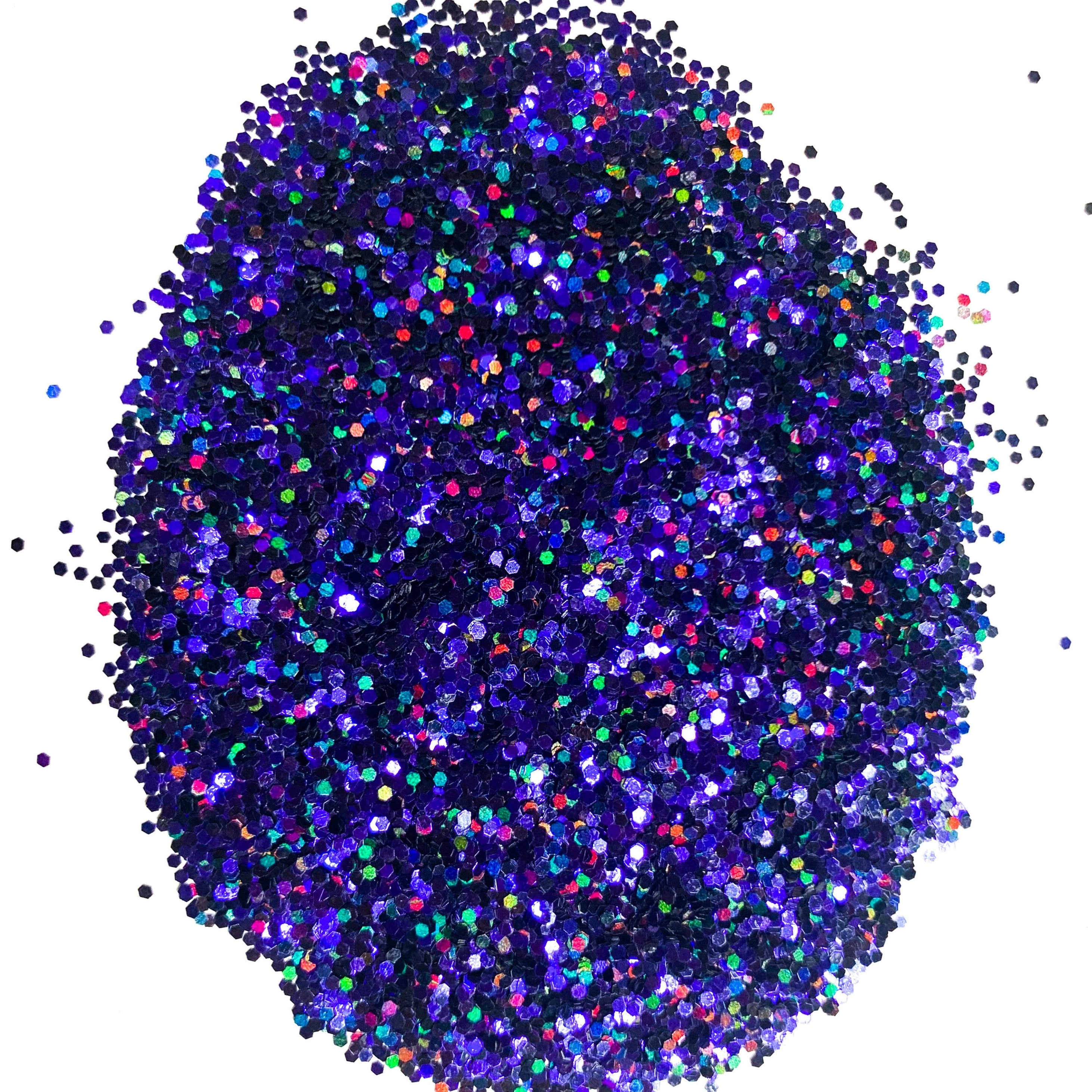 A close-up image of multicolored round glitter pieces, predominantly purple, against a white background.