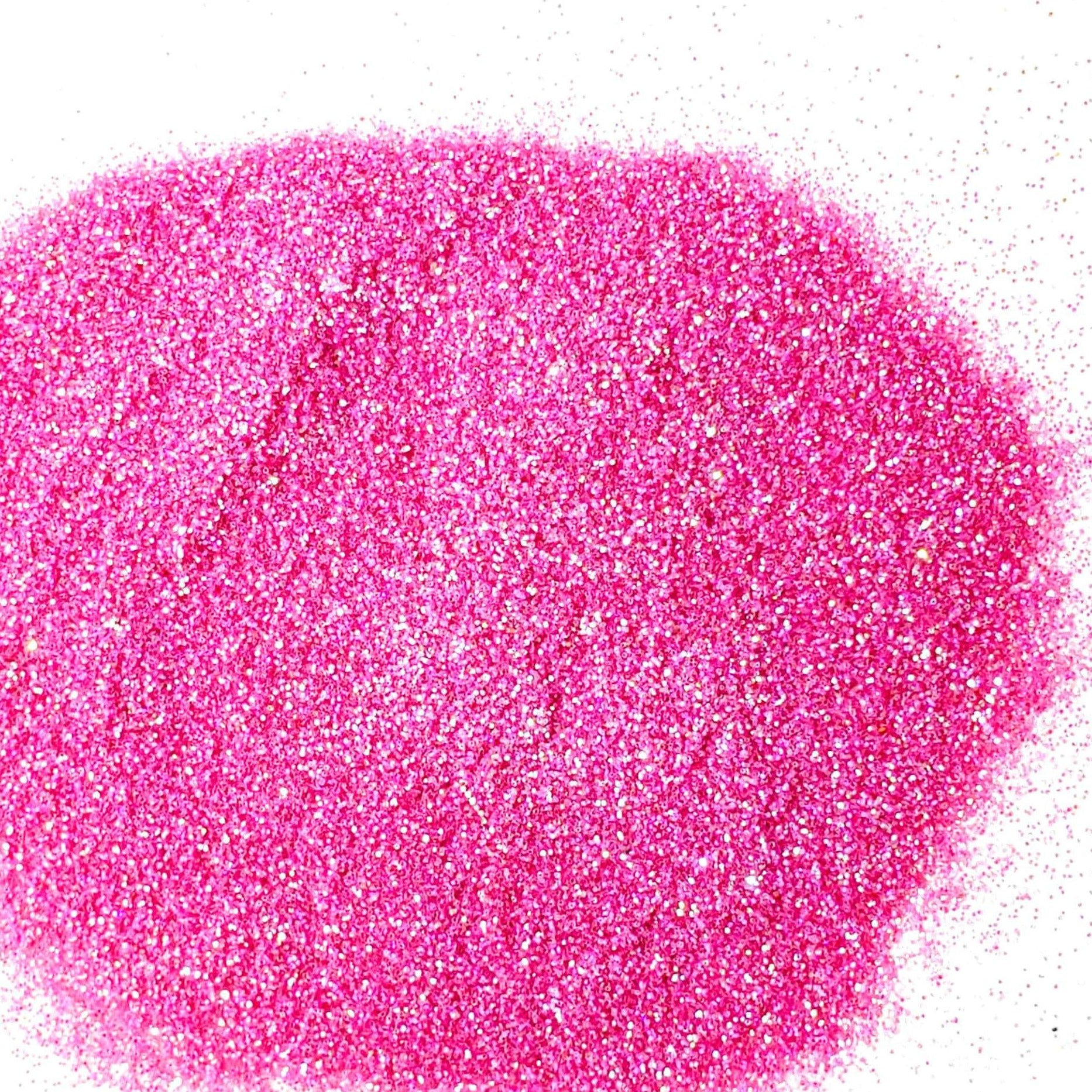 A pile of pink glitter, in extra fine on a white background.